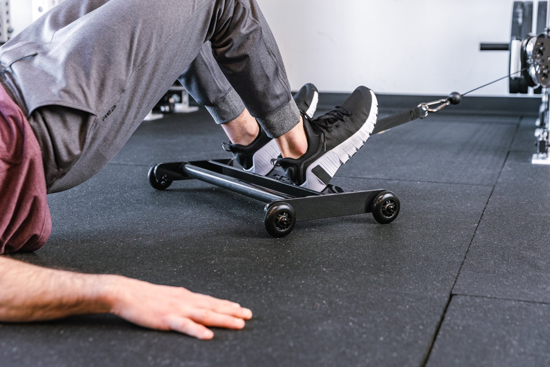 athlete using glute ham roller with strap attached to a functional trainer