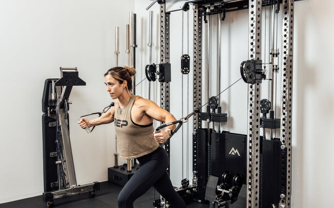 An athlete performing cable chest flys on the Wall-Mounted Ares™ 2.0